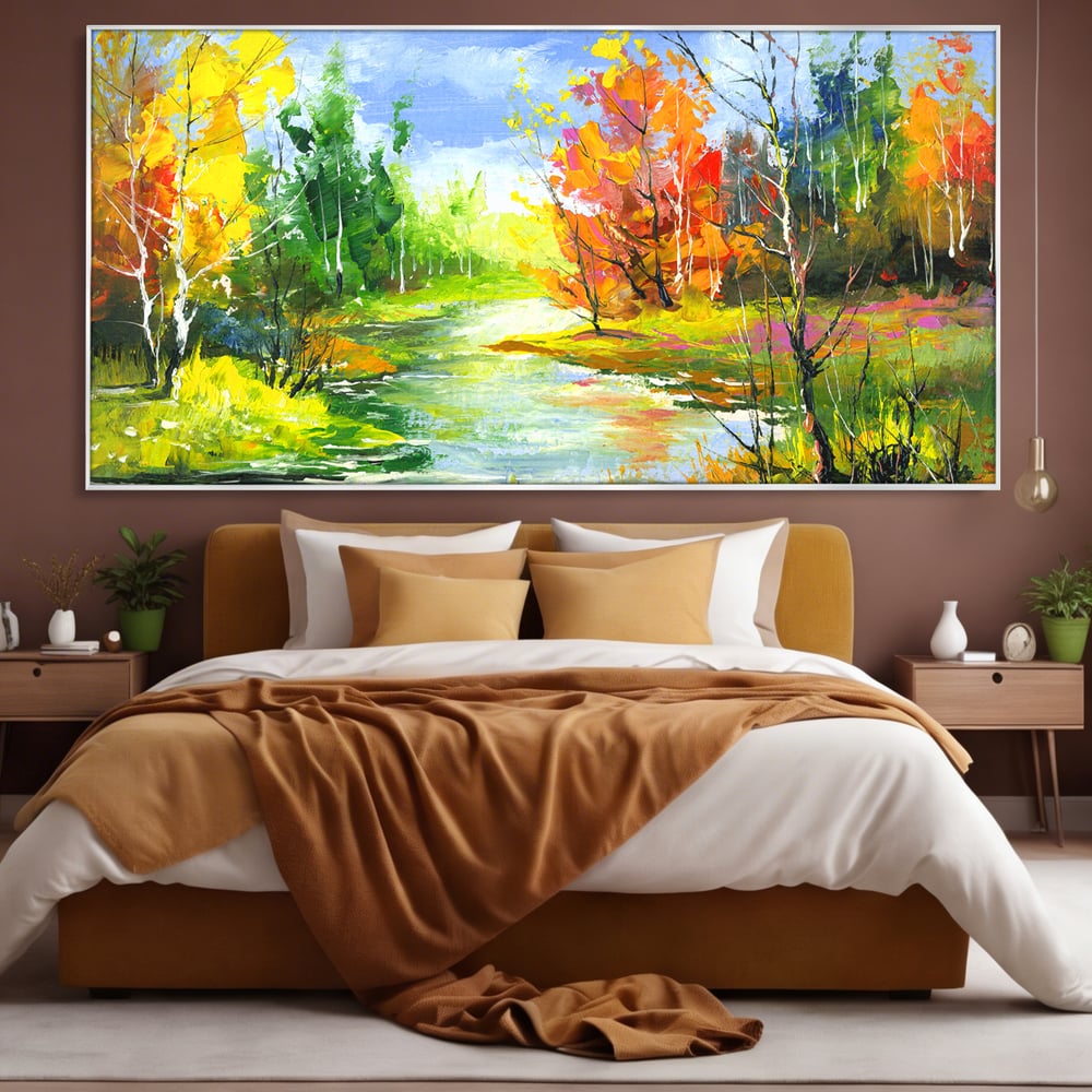 Tablou canvas cu pictura peisaj de toamna cu rau, in rama de aluminiu argintiu, pe perete intr-un dormitor
